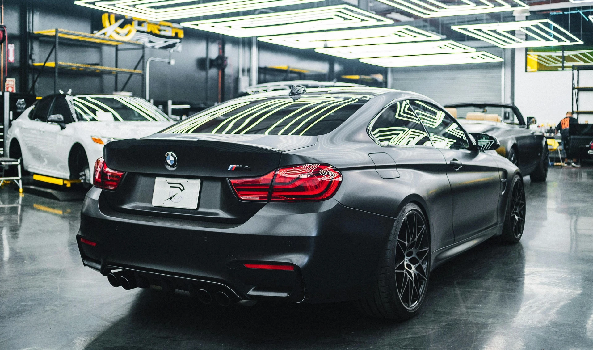 BMW M4 von hinten in der Werkstatthalle von WerkstattFlow-Performance